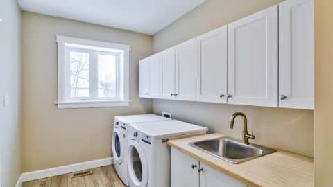 Cabinets and sink in laundry room (per plan).