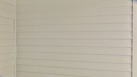 Cement Fiber Board or Composite siding and trim on sides and back.
